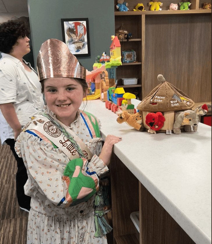 Little Cherokee Abassador-Miss KennaFay, posing with the Cherokee 7 Clan Collection at the new Cherokee Wellness Center Gift Shop in Tahlequah, Oklahoma.